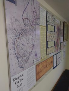 Showing the wall display of "Kingston: On The Map" with large print of NJ map and other items